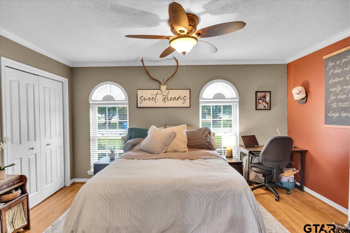 906 Zola Street Quitman, TX 75783 - Photo 25 of 41 a bedroom with a bed and a chandelier