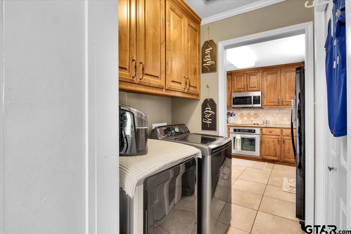 906 Zola Street Quitman, TX 75783 - Photo 30 of 41 a kitchen with stainless steel appliances granite countertop a stove and a microwave