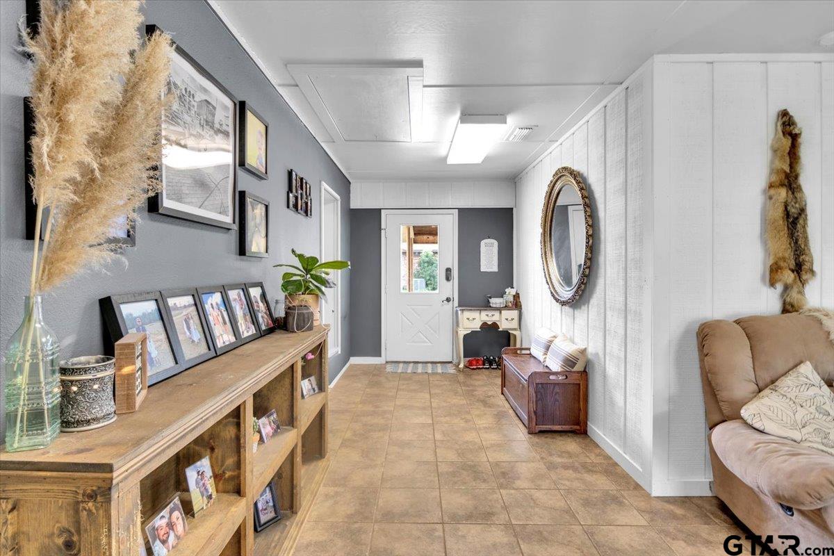 906 Zola Street Quitman, TX 75783 - Photo 32 of 41 a living room with furniture and a mirror
