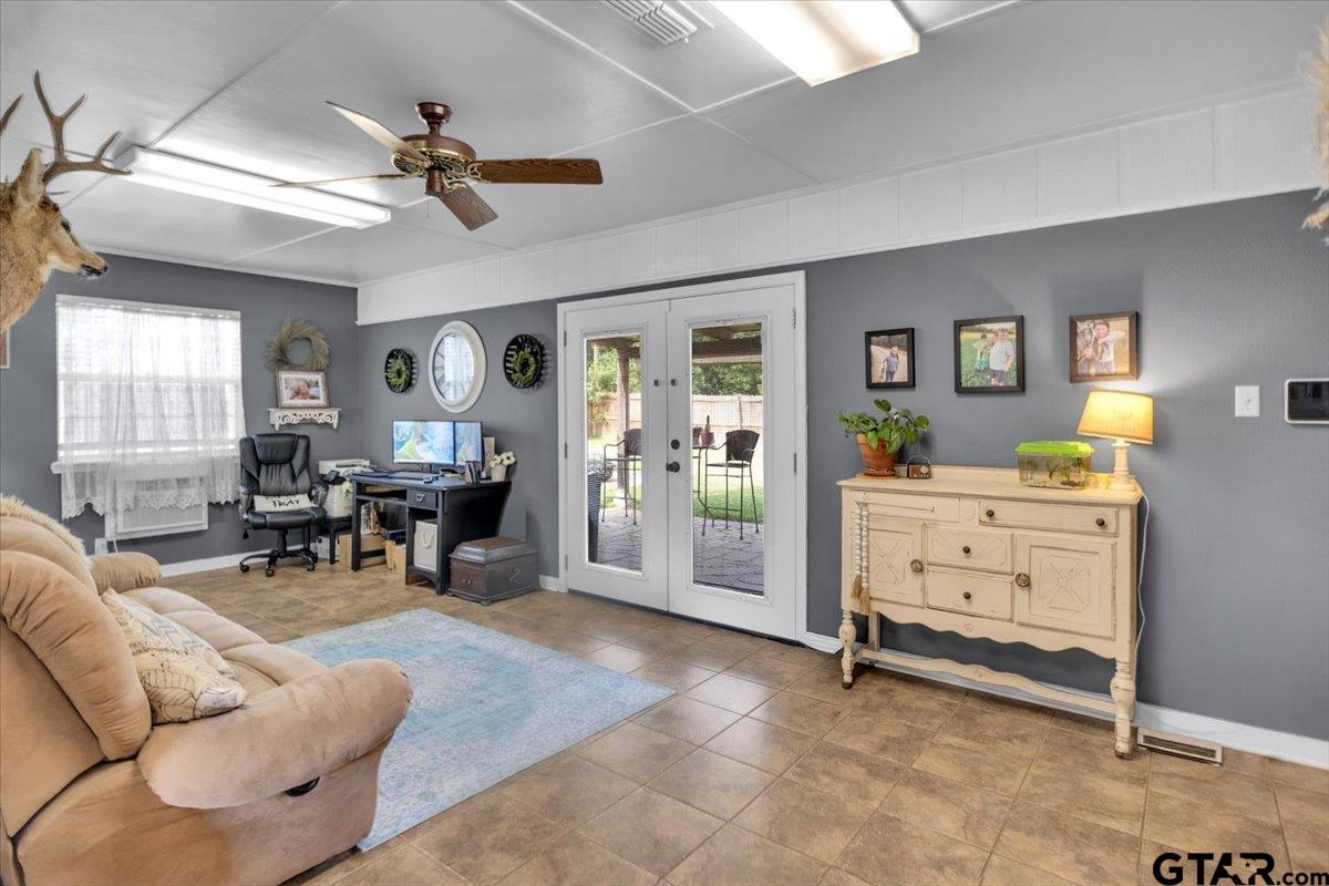 906 Zola Street Quitman, TX 75783 - Photo 35 of 41 a living room with furniture and paintings on the wall