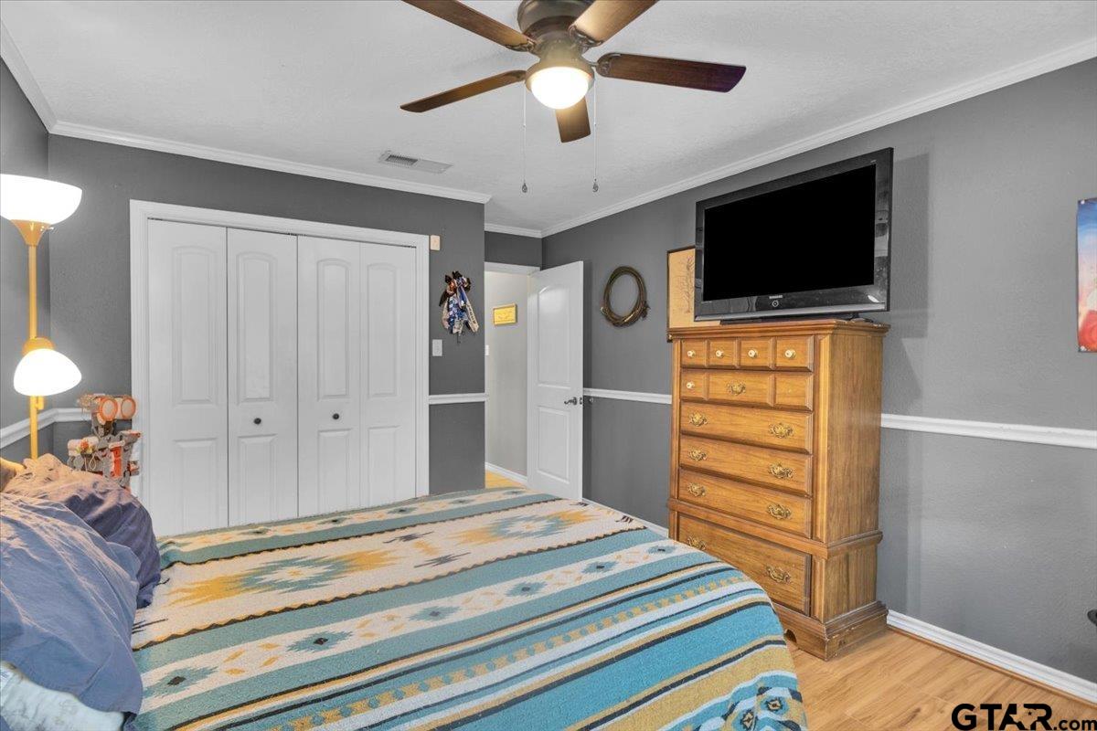 906 Zola Street Quitman, TX 75783 - Photo 40 of 41 a bedroom with a bed and a flat screen tv