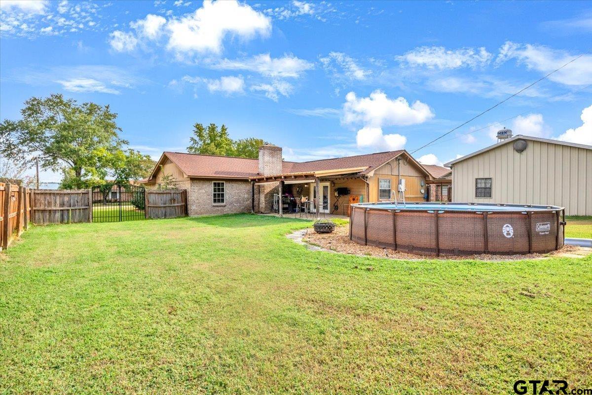 906 Zola Street Quitman, TX 75783 - Photo 7 of 41 a view of a house with a yard and sitting area