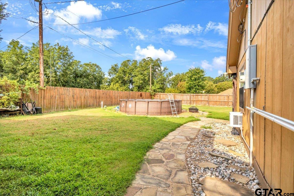 906 Zola Street Quitman, TX 75783 - Photo 8 of 41 a view of a garden with a slide