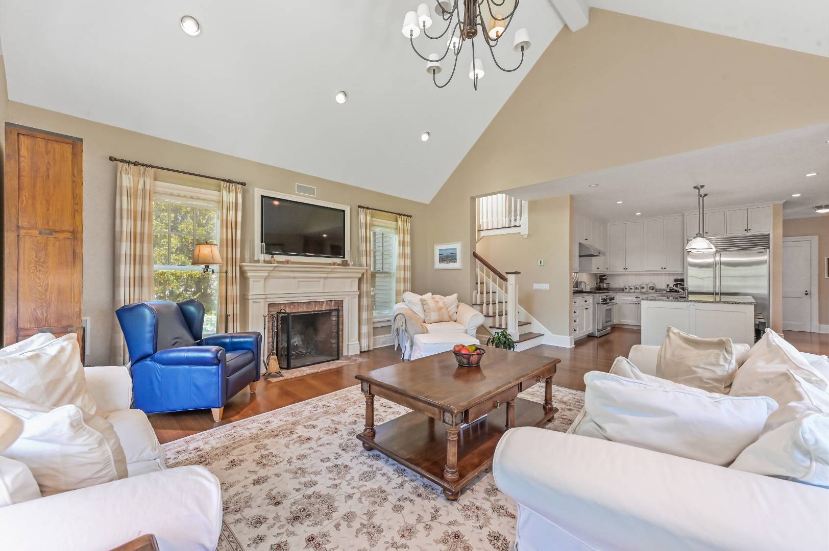 15 Dock Road Remsenburg, NY 11960 - Photo 6 of 34 a living room with furniture a fireplace and a flat screen tv