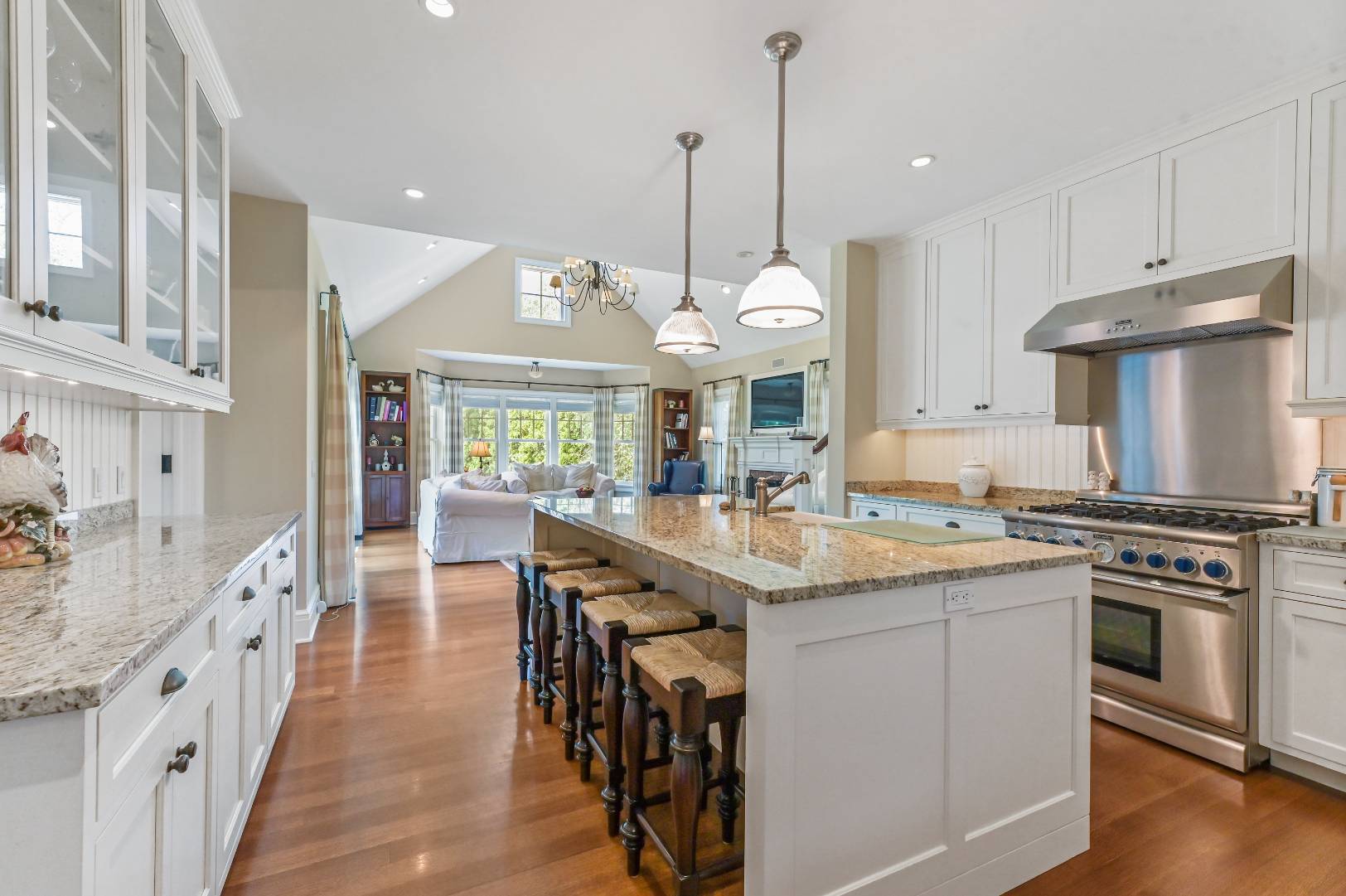 15 Dock Road Remsenburg, NY 11960 - Photo 7 of 34 a kitchen with stainless steel appliances granite countertop a stove a sink dishwasher and a refrigerator with wooden floor