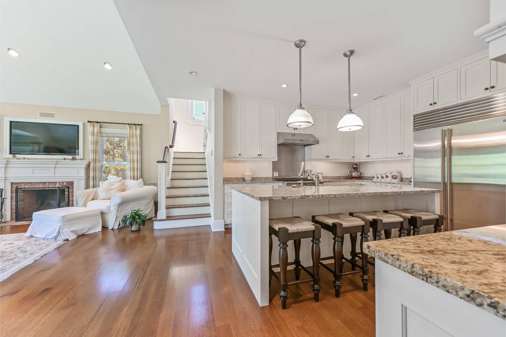 15 Dock Road Remsenburg, NY 11960 - Photo 9 of 34 a large kitchen with cabinets chairs and wooden floor
