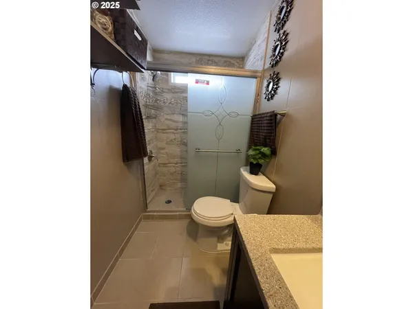 a bathroom with a toilet and a shower