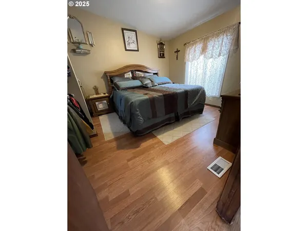a living room with a bed and a window