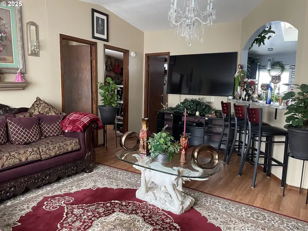 a living room with furniture and a chandelier