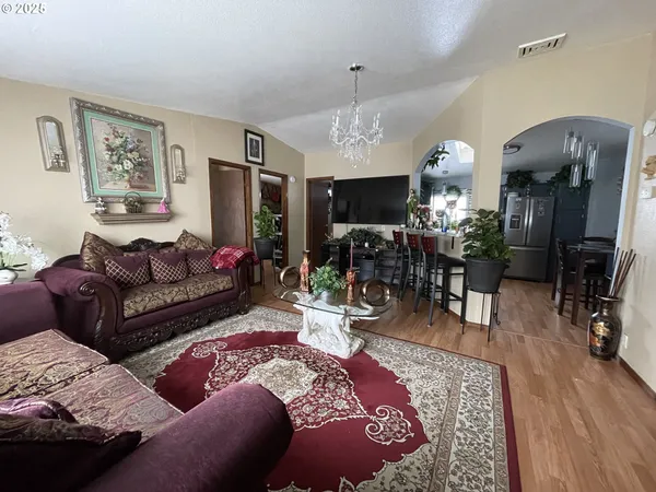 a living room with furniture a dining table and a fireplace