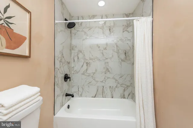 a bathroom with a bathtub and a shower