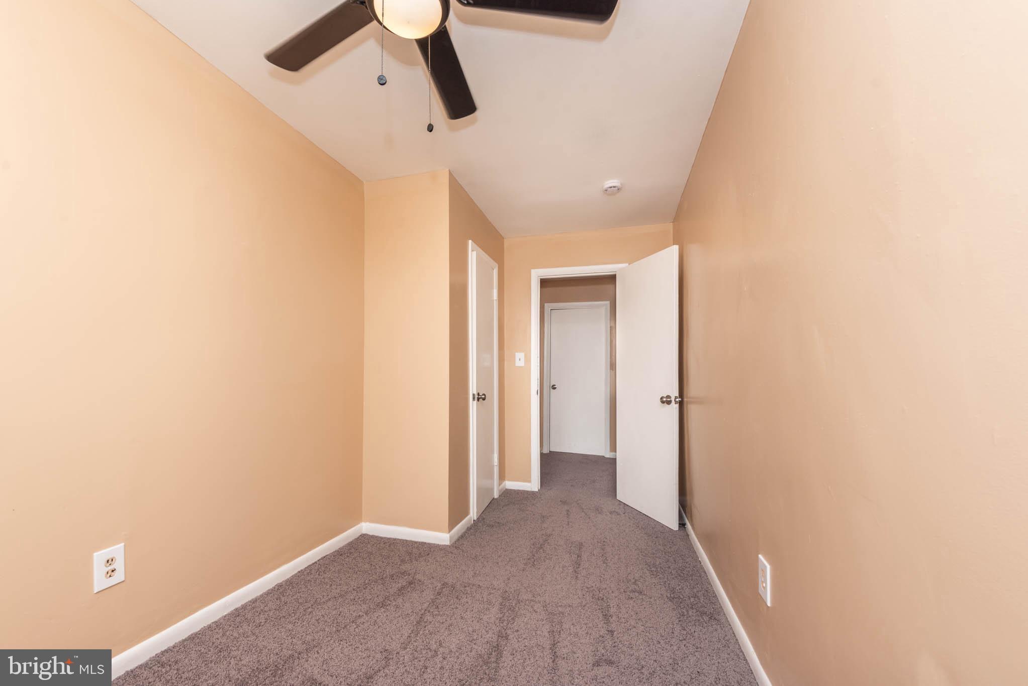 1705 East 25th Street Baltimore, MD 21213 - Photo 12 of 21 a view of hallway with a window and a ceiling fan