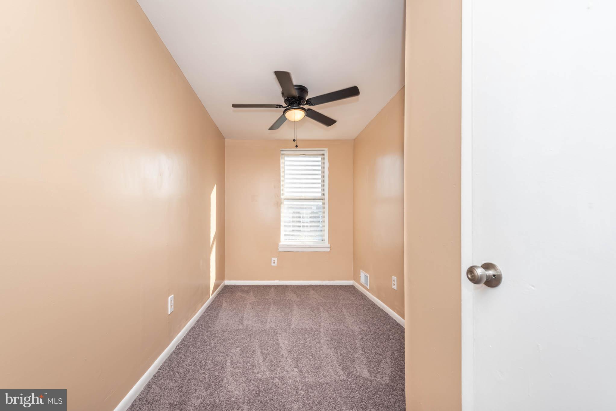 1705 East 25th Street Baltimore, MD 21213 - Photo 13 of 21 a view of a livingroom with a ceiling fan and window