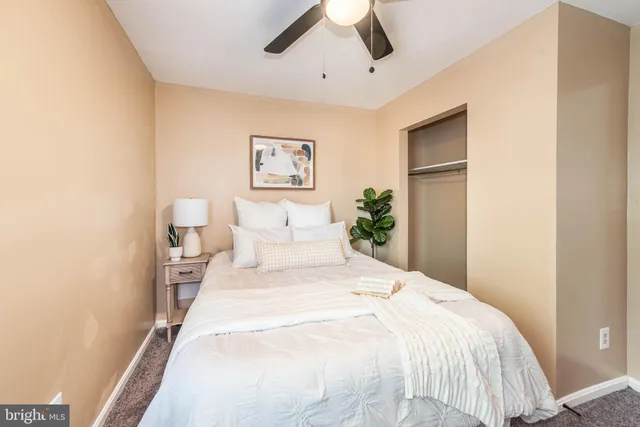 a bedroom with a bed and a painting on the wall