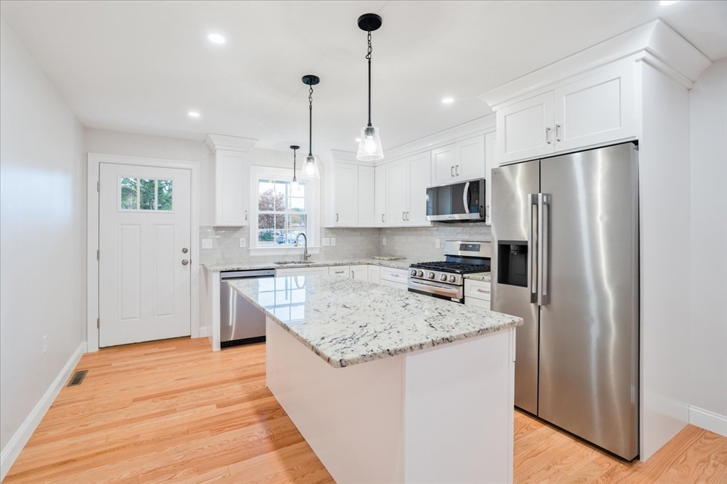 515 Mendon Road, Unit 515 Attleboro, MA 02703 - Photo 11 of 33 a kitchen with stainless steel appliances granite countertop a refrigerator a sink a stove and oven