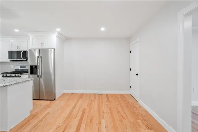 a view of a kitchen with a sink and a refrigerator