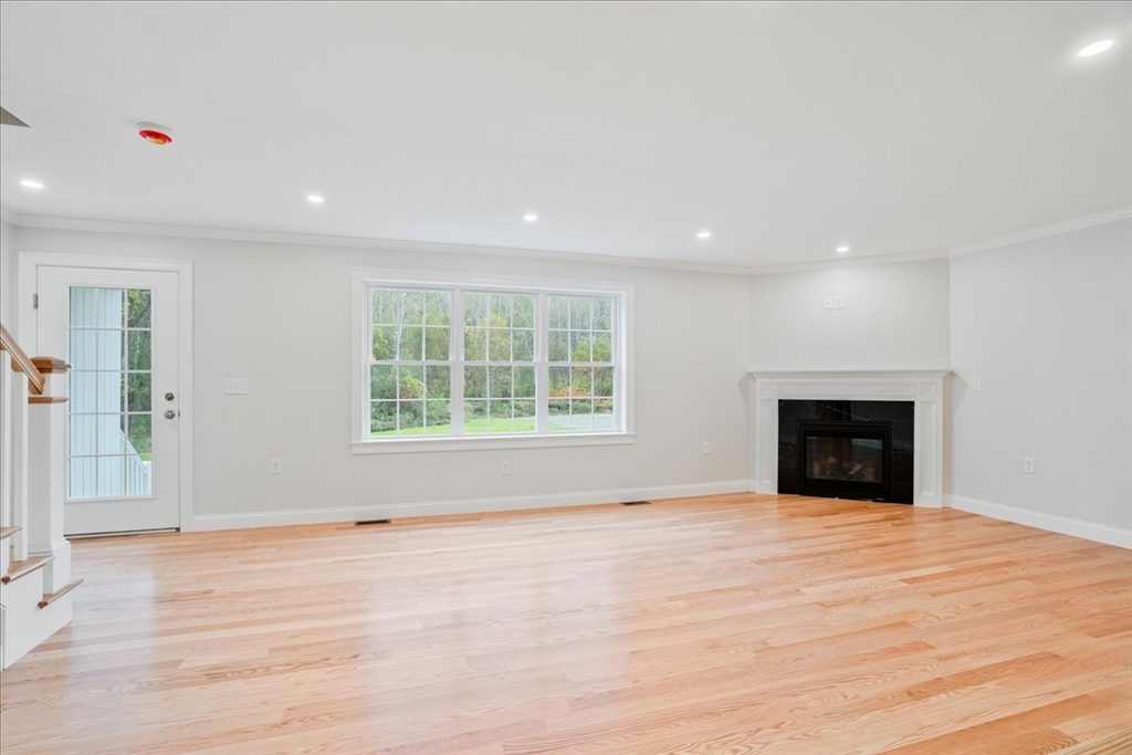 515 Mendon Road, Unit 515 Attleboro, MA 02703 - Photo 15 of 33 a view of an empty room with window and wooden floor