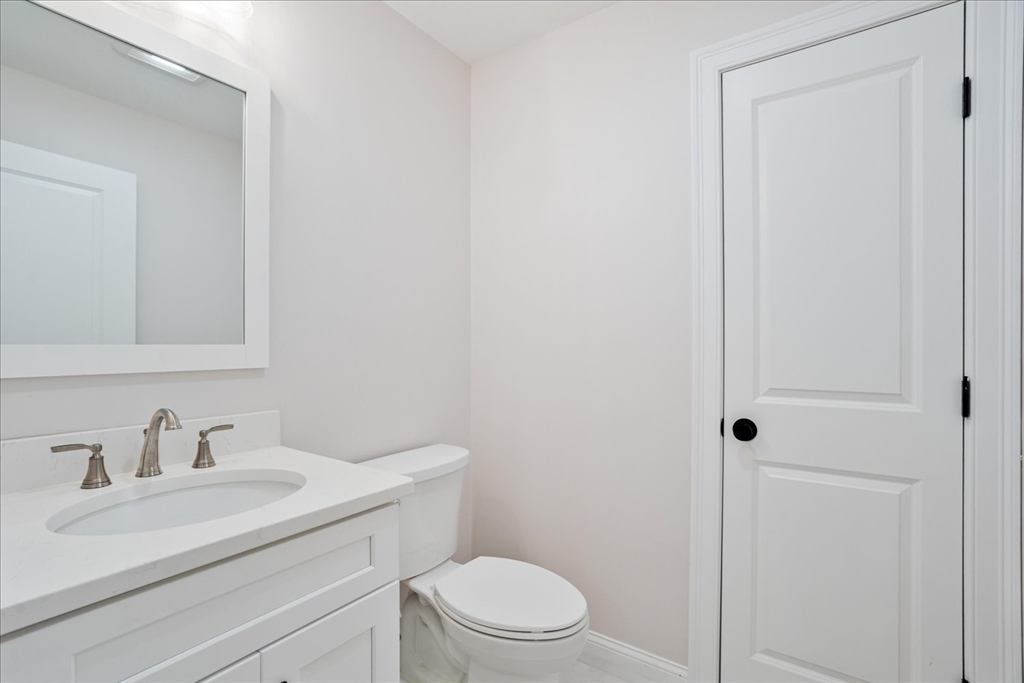 515 Mendon Road, Unit 515 Attleboro, MA 02703 - Photo 19 of 33 a bathroom with a sink a toilet and a mirror