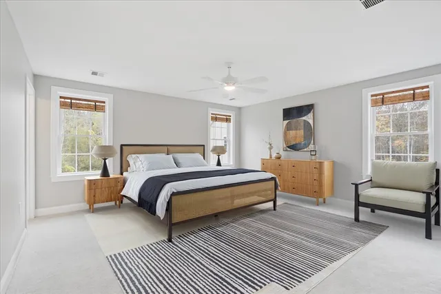 a bed room with a bed and a chair