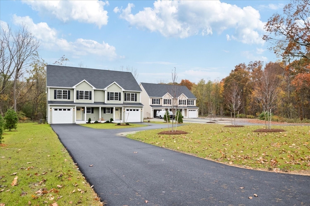 515 Mendon Road, Unit 515 Attleboro, MA 02703 - Photo 3 of 33 a view of a large white house with a big yard and palm trees