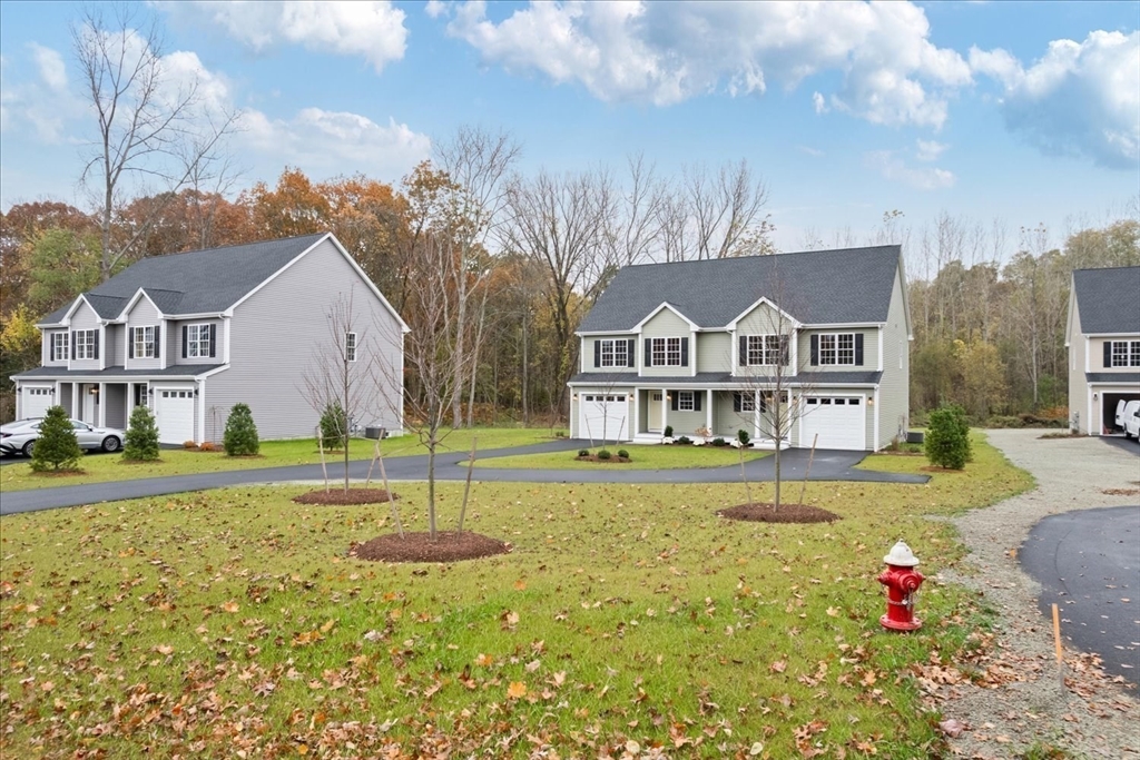 515 Mendon Road, Unit 515 Attleboro, MA 02703 - Photo 4 of 33 a view of a house with a big yard and large trees