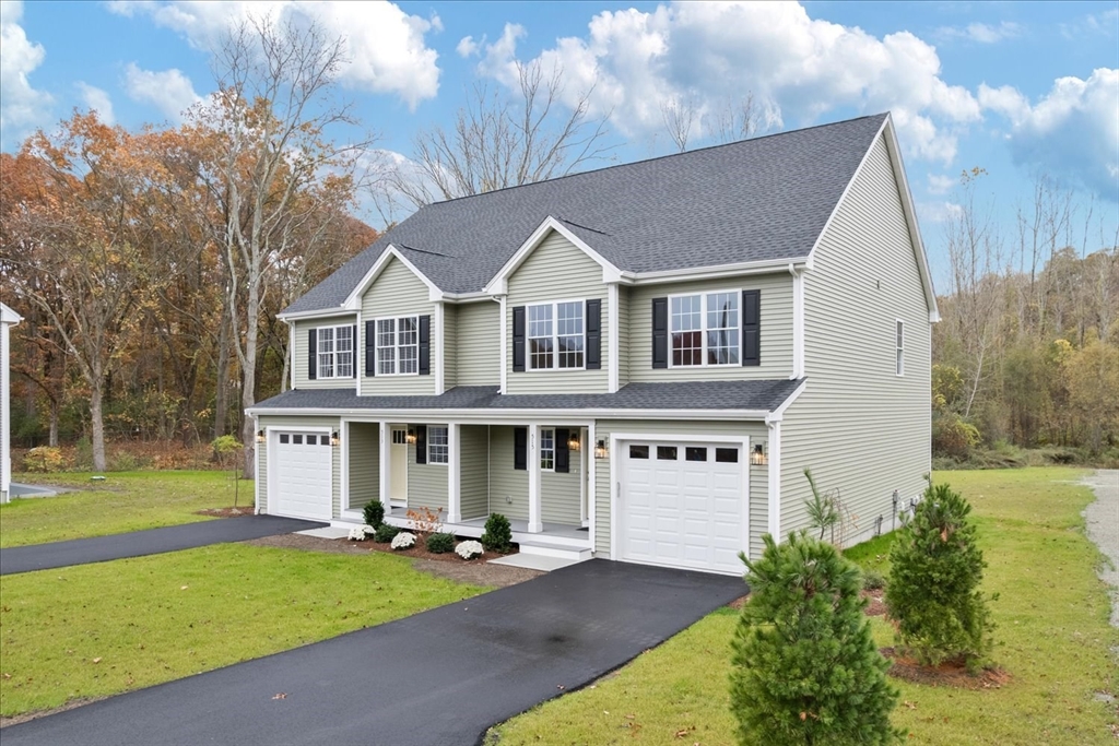 515 Mendon Road, Unit 515 Attleboro, MA 02703 - Photo 6 of 33 a view of a white house with a big yard and potted plants