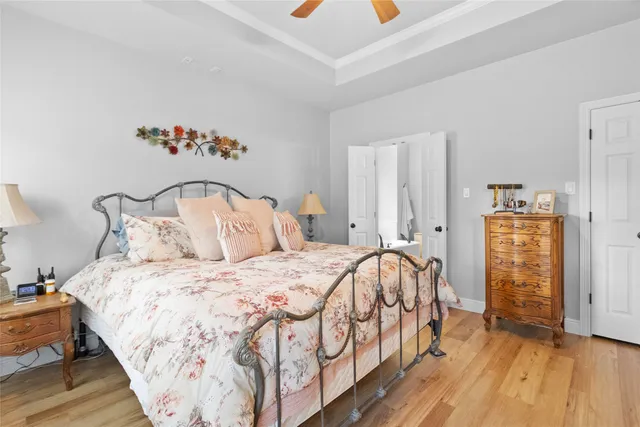 a bedroom with bed and wooden floor