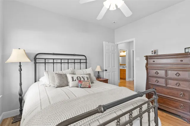 a bedroom with a bed and a mirror