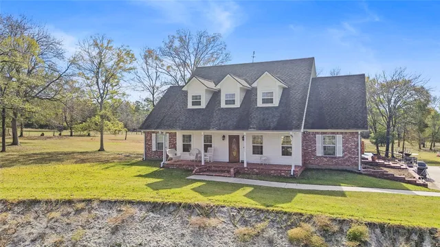 a view of a swimming pool in front of residential houses