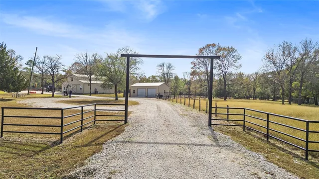 a view of yard with swimming pool and large tree