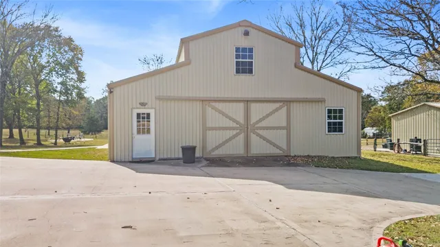 an aerial view of residential houses with outdoor space and trees