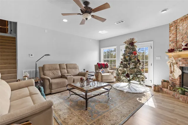 a living room with furniture and a potted plant