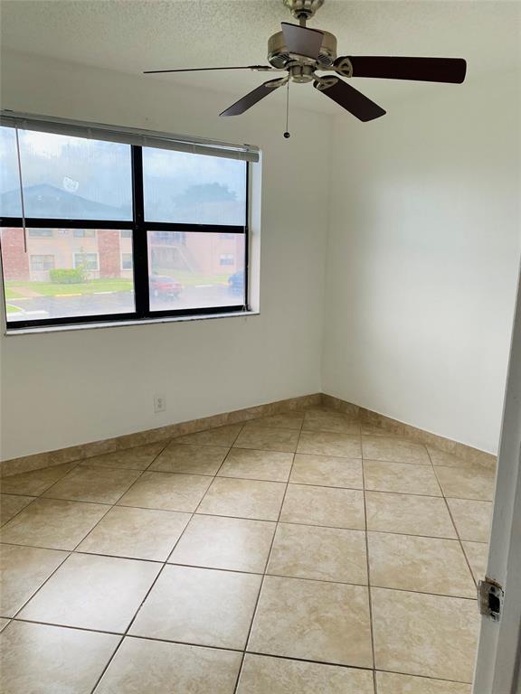 10046 Winding Lake Road, Unit 203 Sunrise, FL 33351 - Photo 12 of 31 a view of an empty room with a window