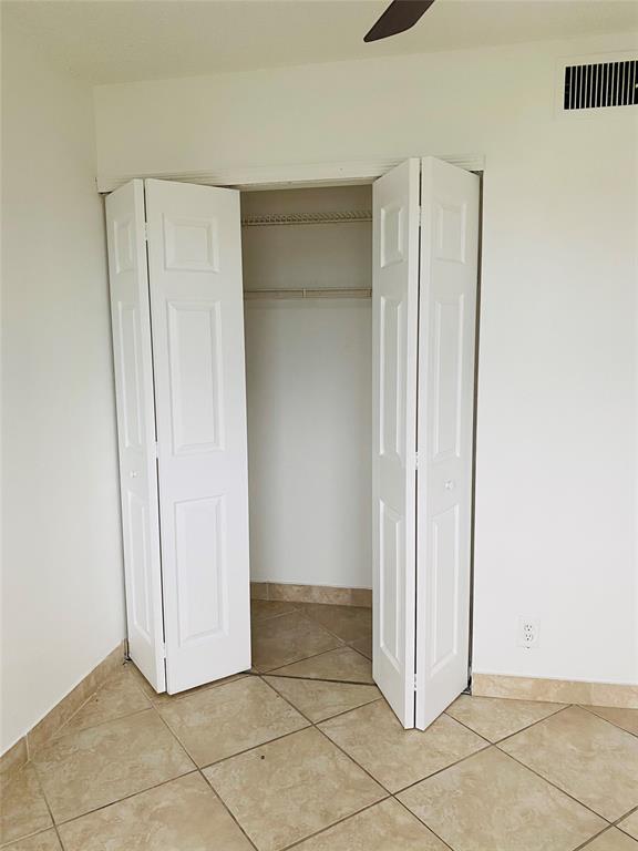 10046 Winding Lake Road, Unit 203 Sunrise, FL 33351 - Photo 14 of 31 a view of a refrigerator in kitchen and white cabinets