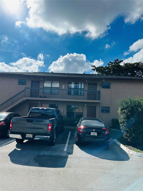 10046 Winding Lake Road, Unit 203 Sunrise, FL 33351 - Photo 19 of 31 a car parked in front of a house