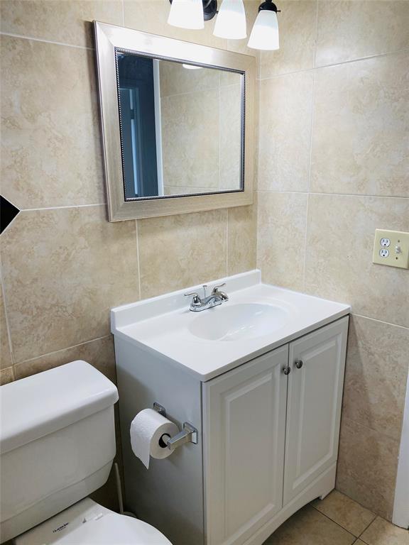 10046 Winding Lake Road, Unit 203 Sunrise, FL 33351 - Photo 22 of 31 a bathroom with a sink a toilet and mirror