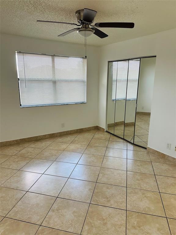 10046 Winding Lake Road, Unit 203 Sunrise, FL 33351 - Photo 26 of 31 a view of an empty room with a window