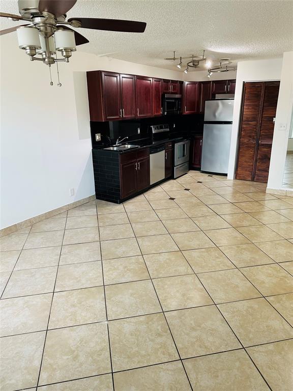 10046 Winding Lake Road, Unit 203 Sunrise, FL 33351 - Photo 29 of 31 a kitchen with stainless steel appliances cabinets and counter space