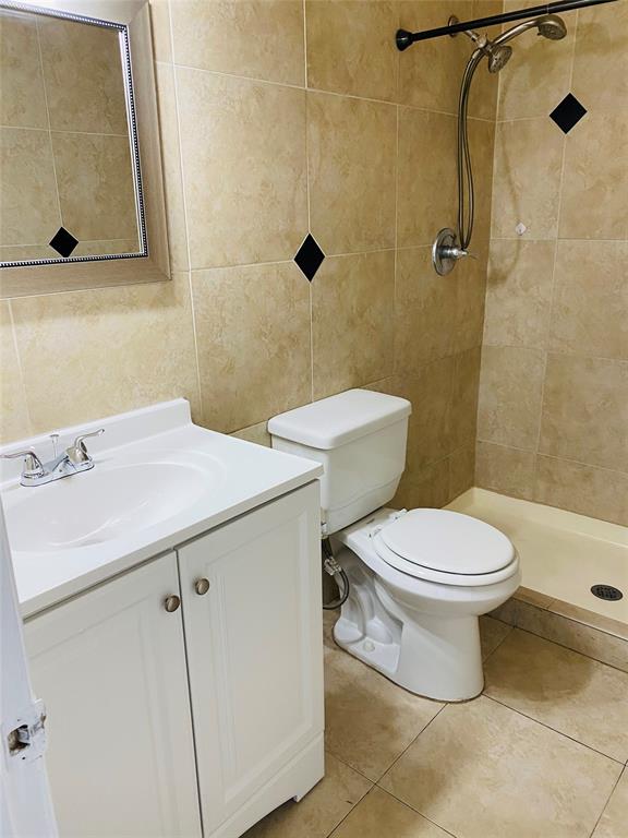 10046 Winding Lake Road, Unit 203 Sunrise, FL 33351 - Photo 6 of 31 a bathroom with a sink a toilet and shower