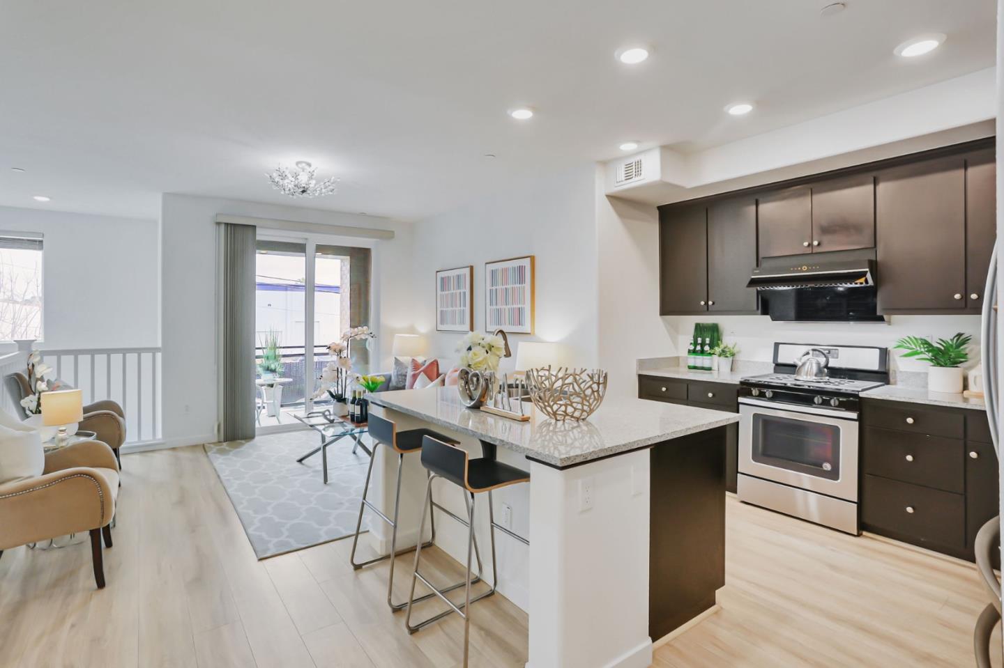 1883 Dobbin Drive San Jose, CA 95133 - Photo 7 of 27 a kitchen with stainless steel appliances kitchen island granite countertop a stove top oven a sink a dining table and chairs