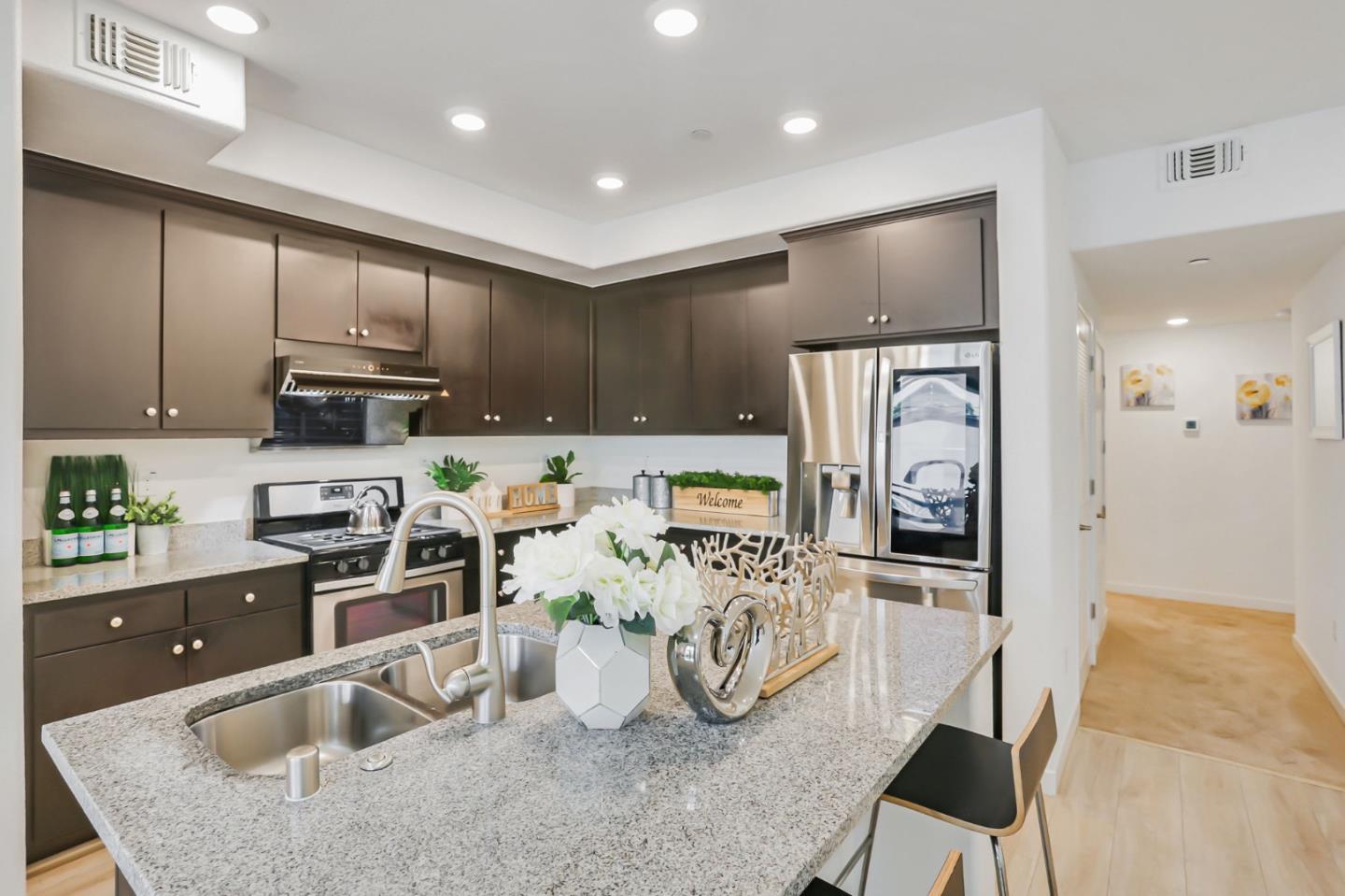 1883 Dobbin Drive San Jose, CA 95133 - Photo 8 of 27 a kitchen with stainless steel appliances granite countertop a sink refrigerator and cabinets