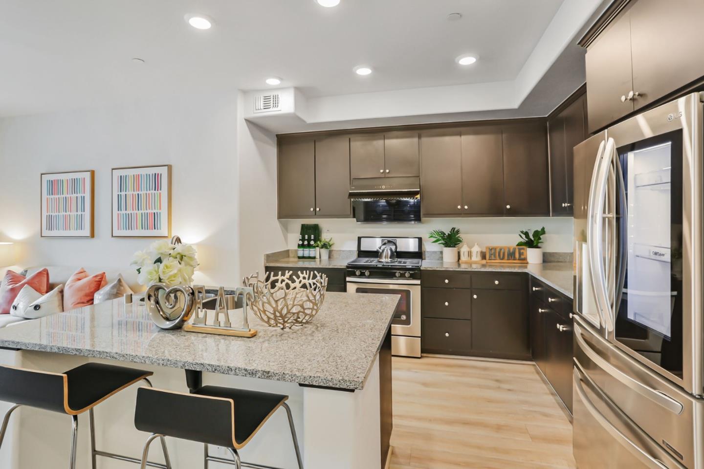 1883 Dobbin Drive San Jose, CA 95133 - Photo 9 of 27 a kitchen with stainless steel appliances granite countertop a refrigerator a stove top oven a sink dishwasher and white cabinets with wooden floor