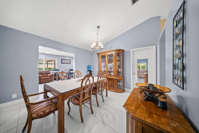a bedroom with a bed and a dresser with mirror