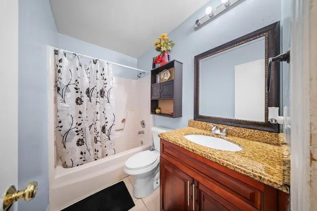 a kitchen with stainless steel appliances granite countertop a refrigerator a sink dishwasher a stove and white countertops with wooden floor