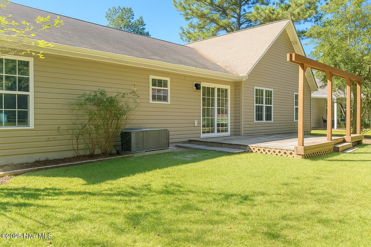Rear patio with sliding glass doors to lovely patio. Back yard is private, backs to trees.