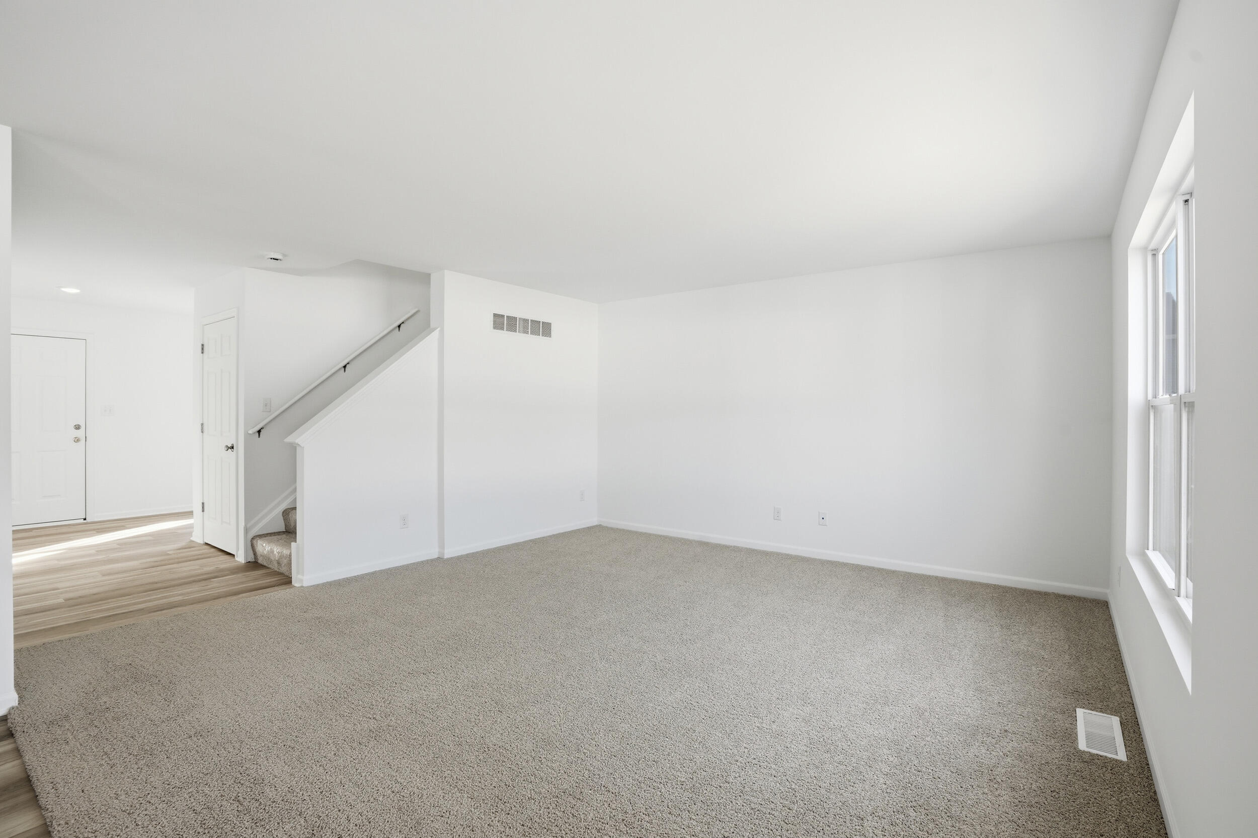 10392 Knox Street Crown Point, IN 46307 - Photo 8 of 31 an empty room with staircase and white walls