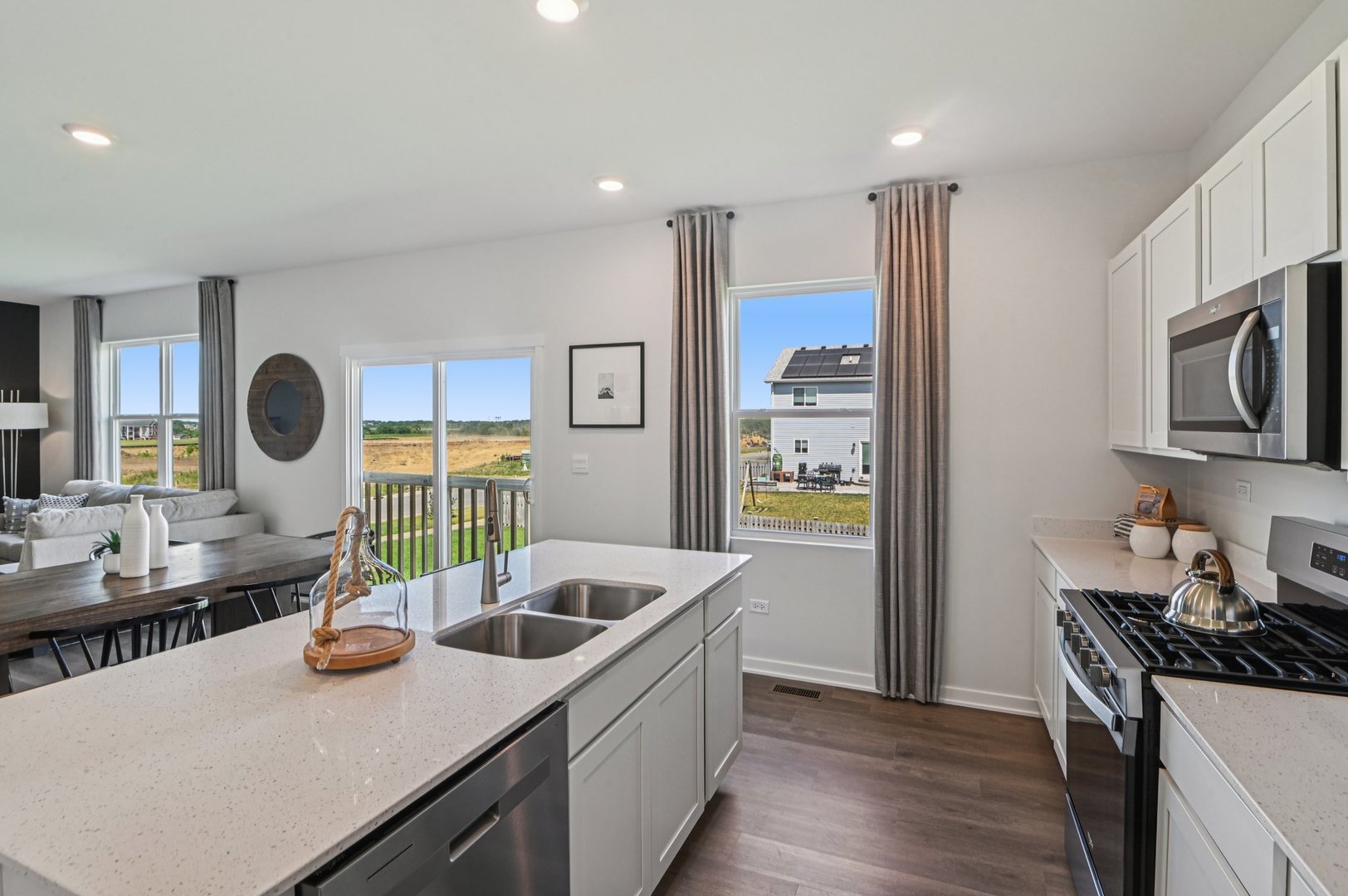 966 Garnet Lane Montgomery, IL 60538 - Photo 43 of 62 a kitchen with stainless steel appliances kitchen island granite countertop a sink a stove and wooden cabinets