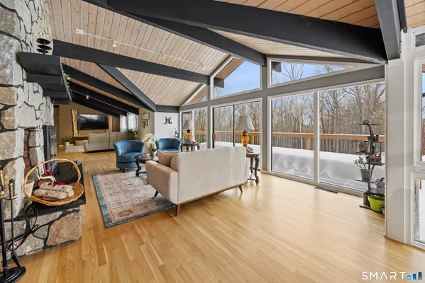a living room with furniture and a floor to ceiling window