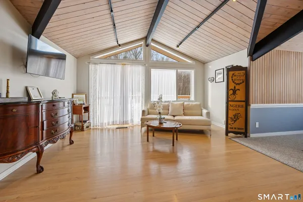 a living room with furniture and a wooden floor