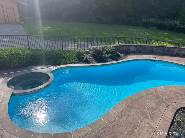 a view of a swimming pool with a yard